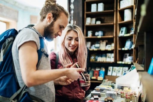 Young traveling couple look at items in a shop