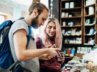 Young traveling couple look at items in a shop