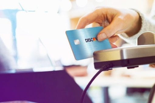 Discover rewards credit card swiped through a card reader.