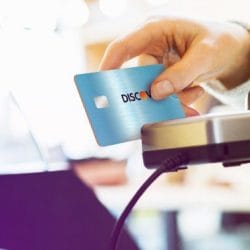 Discover rewards credit card swiped through a card reader.