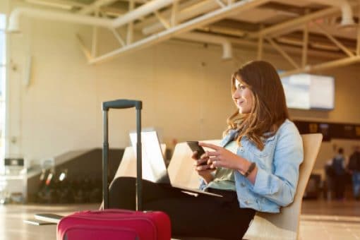 Traveling woman sits in airport