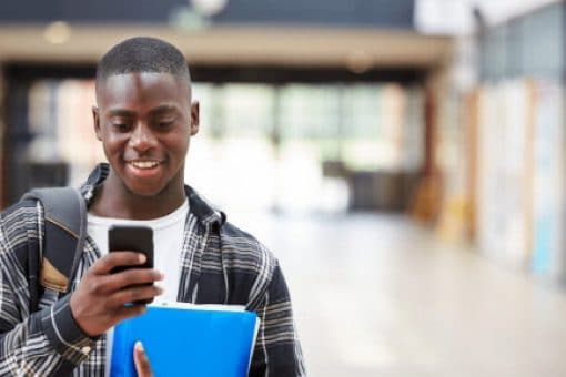 A college student learns about credit card requirements on his mobile phone.