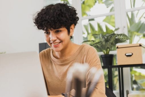 A young college student works on her laptop.