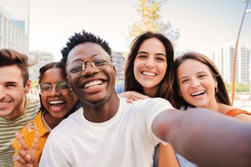 A group of smiling friends take a picture together.