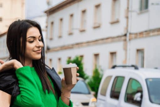 Woman shopping with bags and coffee to go