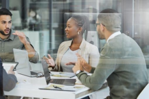 Group of working professionals in a meeting discussing a project.