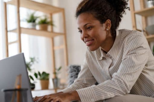 Woman works on laptop at home