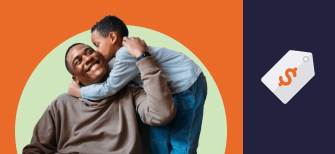 Young boy hugs his seated grandpa around the neck and kisses his cheek