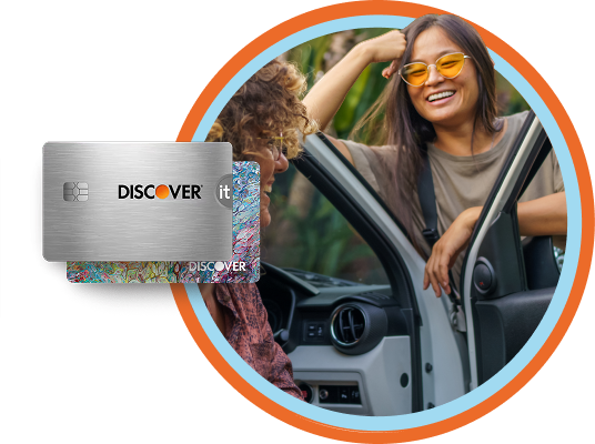 Young woman with orange sunglasses leans on an open car door while taking to her friend
