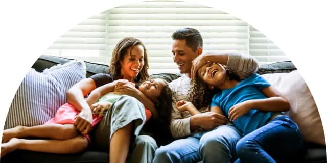 Image of a family on their couch having fun together