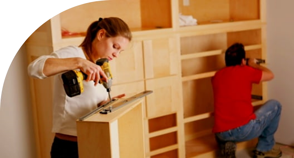Image of couple building cabinets in their new home