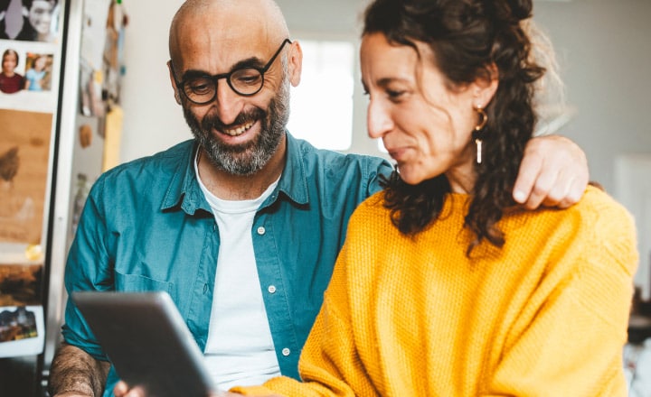 Couple reading tablet