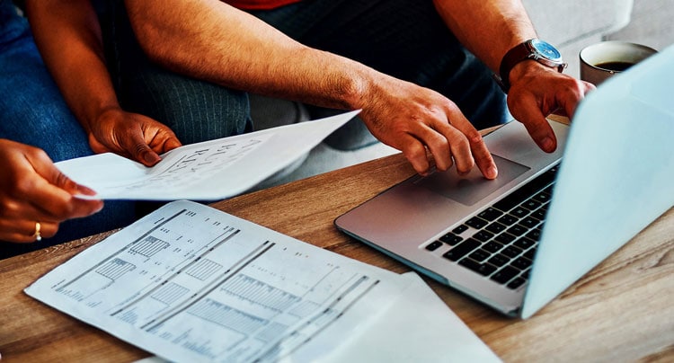 Image of couple reviewing finances on laptop