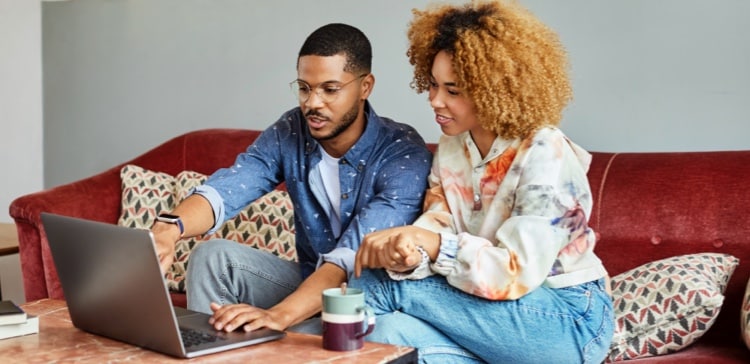 Image of couple reviewing their finances at the computer