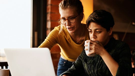 Couple looks at laptop 