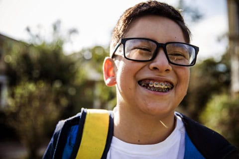 Boy grins showing his braces.