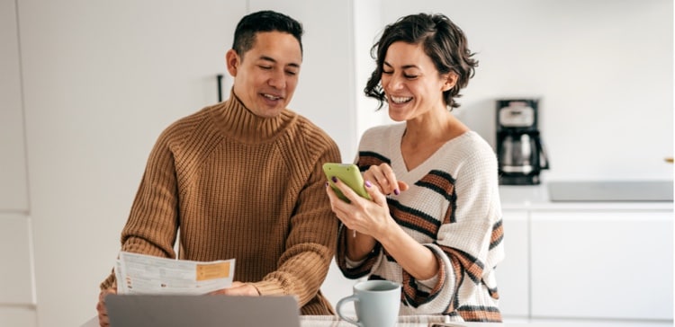 Image of couple in front of computer discussing their finances