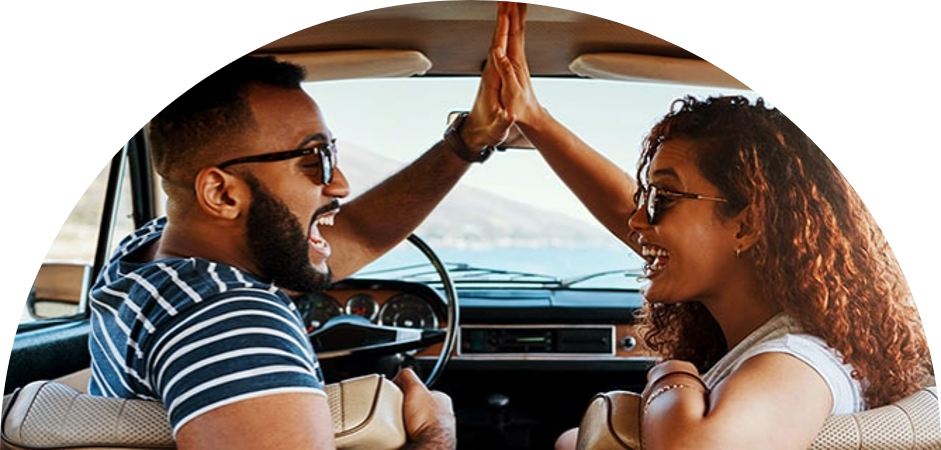 Image of man and woman high-fiving each other in the car
