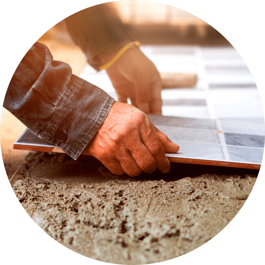 Image of a tile being placed on the ground during a home remodel project