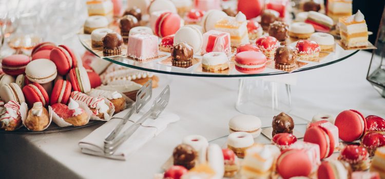 A selection of pink and white macaroons, canolis and other pastries.
