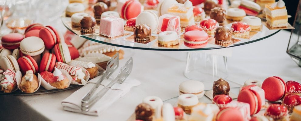 A selection of pink and white macaroons, canolis and other pastries.