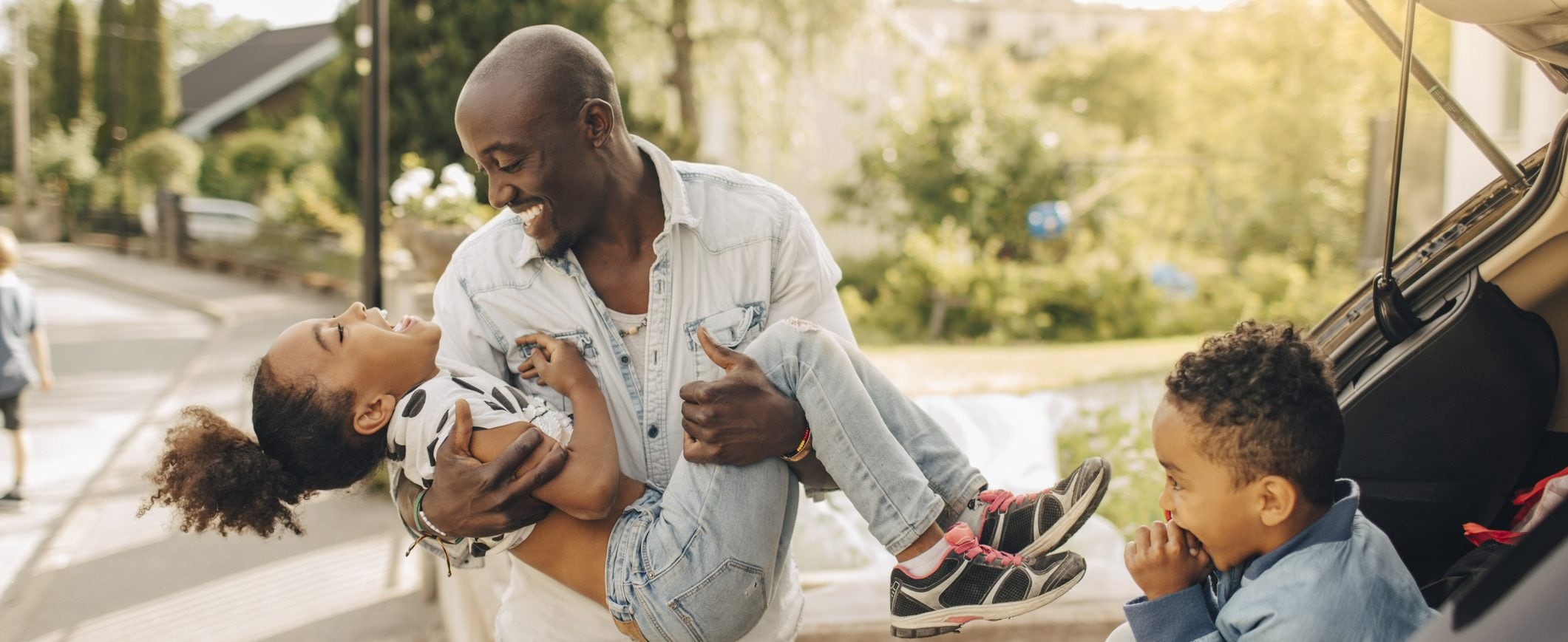 A man spending time with his young children.