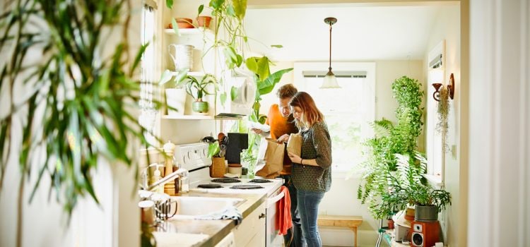 A couple looks through a grocery bag.