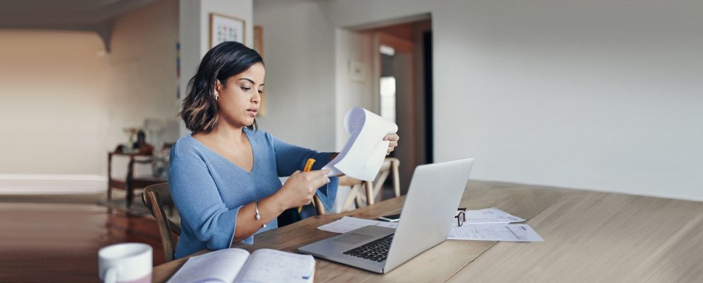 A woman reads off a list in her apartment.