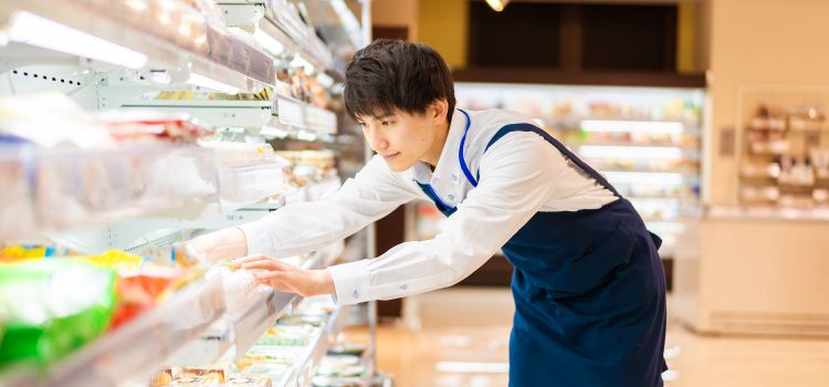 Man stocks shelves in a grocery store.