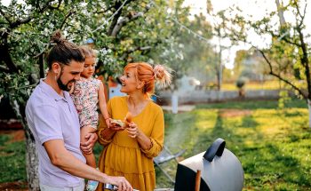 A family are grilling in their backyard