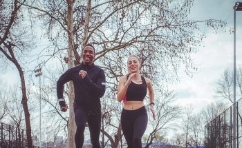 A man and a woman jog outside.
