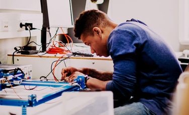 A young man is working on something.